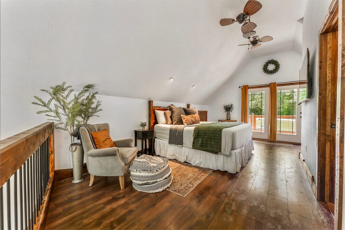 Master bedroom with a king bed, cozy linens and room-darkening shades at the James River Cabin
