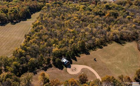 Aerial of the cabin and its winding gravel drive through the Ozark countryside