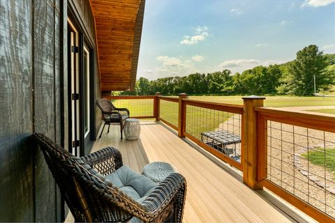 Upper deck with wicker seating and a long view over the valley