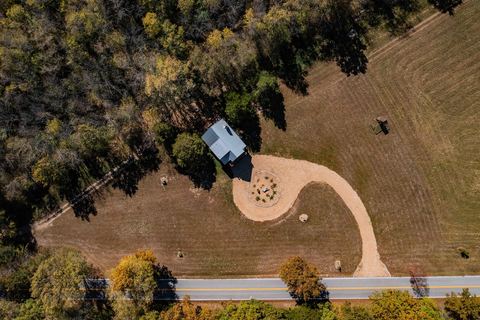 Aerial showing the cabin’s seclusion, set well back from the scenic paved road