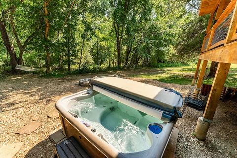 Private hot tub bubbling in the trees, drained, cleaned and refilled between every stay