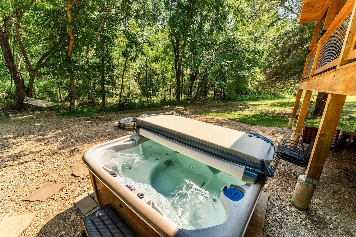 Private hot tub bubbling in the trees, drained, cleaned and refilled between every stay