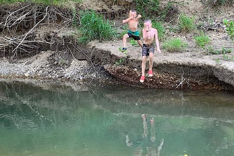 Kids wading at one of the river swimming holes, which shift with the water level