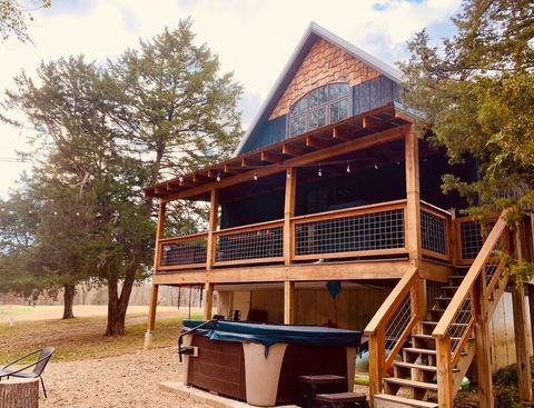The covered back porch added in October 2024, built in cedar with a metal roof