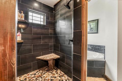 Full bathroom with vanity storage and warm lighting
