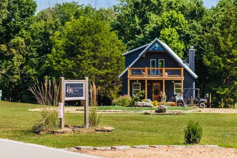 James River Cabin seen from the front lawn with its welcome sign and landscaped beds