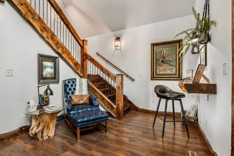 Living area looking toward the tall cabin windows and the trees beyond