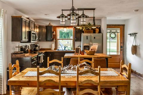 Fully stocked cabin kitchen with butcher-block counters and stainless appliances