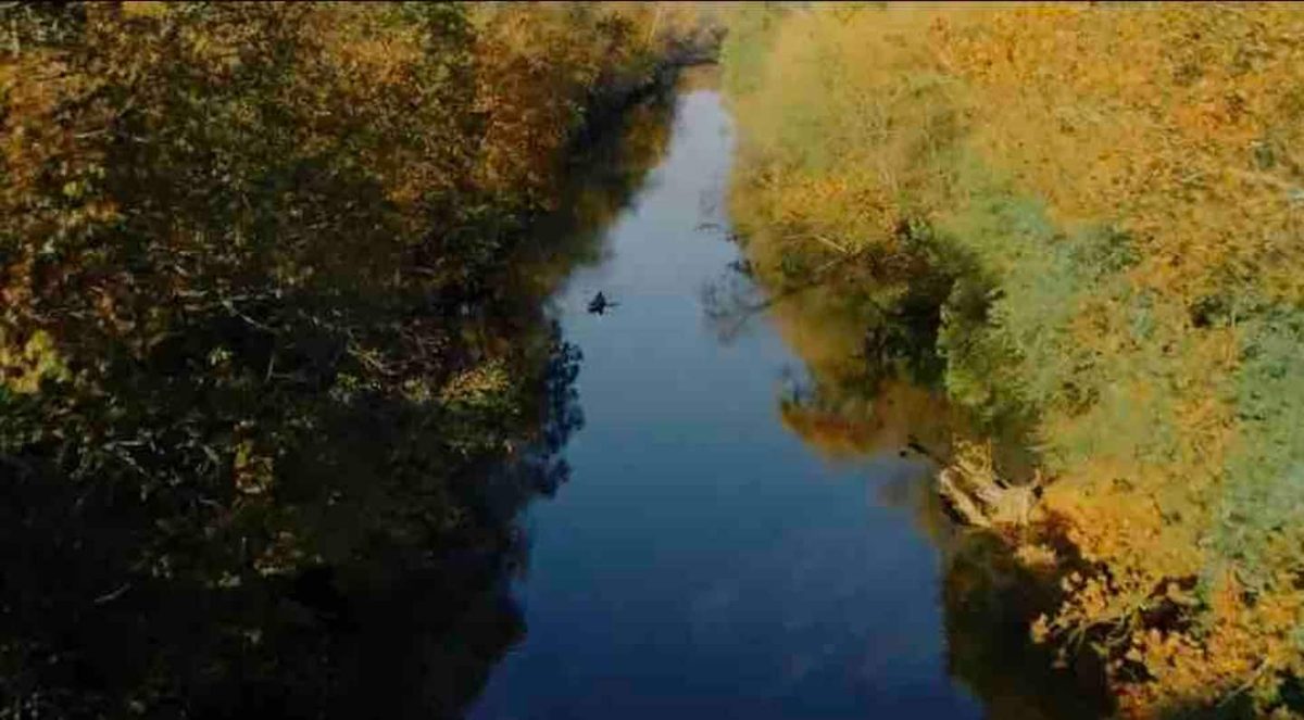 Fall aerial of the riverfront property showing the James River winding through autumn timber