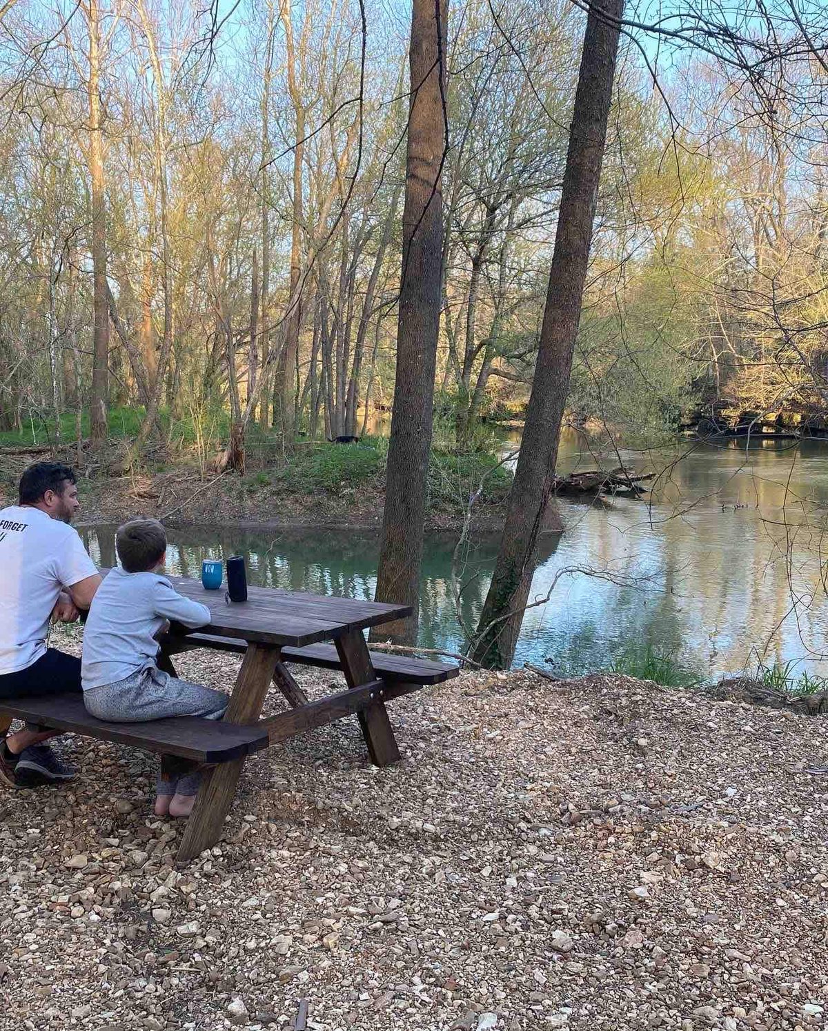 Guests at the riverside picnic table on the James River gravel bar, added in 2022