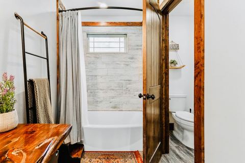 Bright cabin bathroom with modern fixtures and rustic wood accents