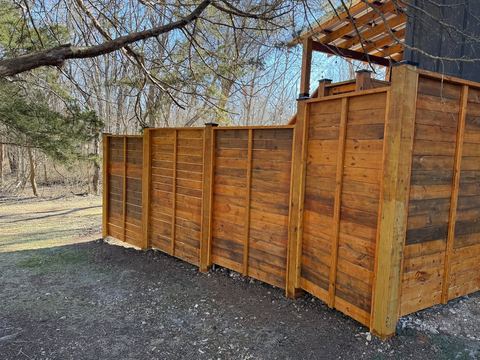 Cedar privacy screen of the outdoor shower set against the woods